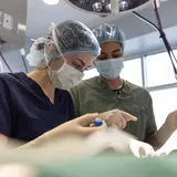 Two medical staff perform a procedure in the clinic