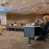 A veterinarian teaches a large room of students the specialties of community animal medicine